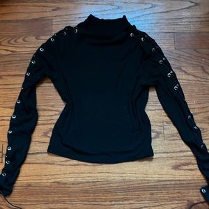 Black mini turtleneck top. Dolls Kill. Very cool sleeve laced up design. Small.
